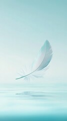 A single feather gently floats above tranquil water, creating a serene and minimalist atmosphere.