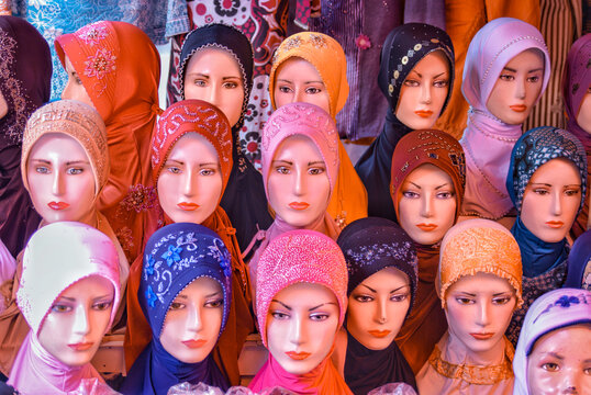 group of mannequin heads wearing muslim head scarf or hijab, displayed at the muslim apparel store. 
