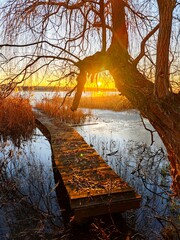 platform for fishing at the reservoir in winter sunset