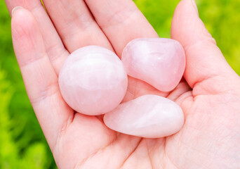 Natural rose quartz minerals in hand. Semi-precious multi-colored stones, minerals close-up. Mineralogy. Collection of minerals.