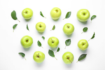 Green apples and leaves on white background, flat lay