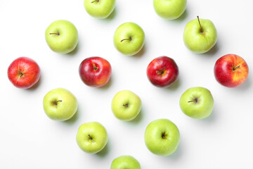 Red and green apples on white background, flat lay