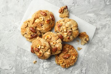 Tasty cookies with nuts on grey table, flat lay