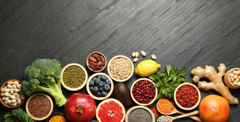 Superfood. Different healthy food products on grey table, flat lay. Space for text