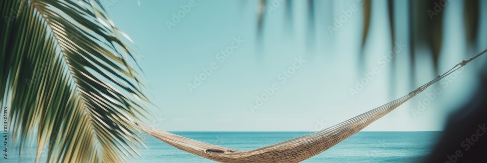 Poster empty hammock hanging between two palm trees on a tropical beach invites to relaxation and evokes a 