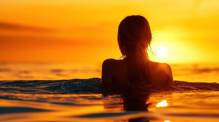 Fototapeta premium Silhouette of a person in water, golden sunset over ocean, warm orange sky, rippling water surface, backlit figure, serene atmosphere, tranquil seascape, dramatic lighting, summer evening, peaceful mo