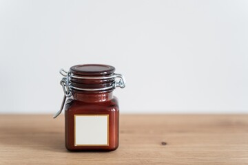 Scented candle in a glass jar on a white background. Glass jar with aromatic candle. High quality photo
