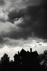 Spooky Silhouette of a Haunted House Under Dark Ominous Clouds