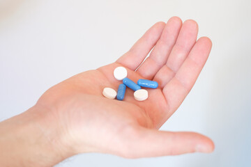 A hand full of medicines pills
