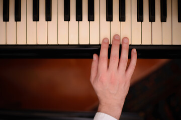 Close-up of a music performer's hand playing the piano
