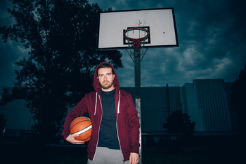Urban basketball player in the court , vintage drama color effect
