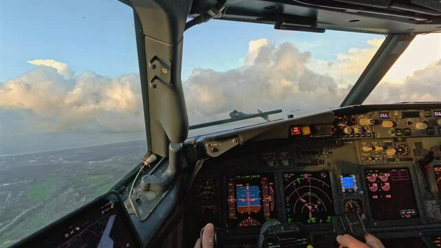 Pilot cockpit view of climbing aircraft banking through clouds