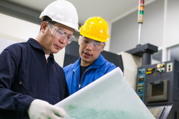 Asian male engineer worker discuss about factory project on planning paper with foreman at industrial plant industry. teamwork corporate people concept