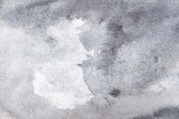 Abstract grey watercolor texture with subtle brush strokes and gradient shades for creative design backgrounds.