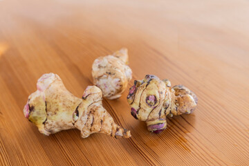 Frische Topinampur Knollen auf einem Holztisch