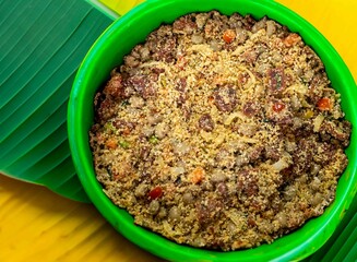 Traditional Brazilian farofa prepared with toasted cassava flour, bacon, onion and typical spices....