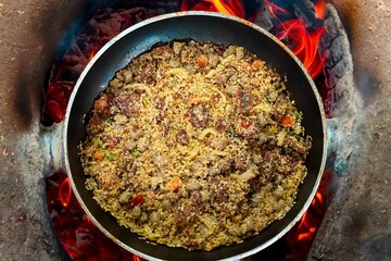 Traditional Brazilian farofa prepared with toasted cassava flour, bacon, onion and typical spices....