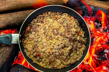 Traditional Brazilian farofa prepared with toasted cassava flour, bacon, onion and typical spices. Brazilian food