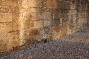 light vintage stone wall and vintage paving stones with perspective