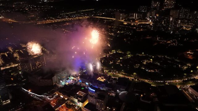 Drone shot capturing a spectacular fireworks display at The Curve, Mutiara Damansara, during New Year's celebrations. A breathtaking aerial view of the festivities.