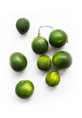 Isolated unripe green lemon fruits, a species of citrus native to Asia commonly used all over the world primarily for drinks such as lemonade or lemon tea.