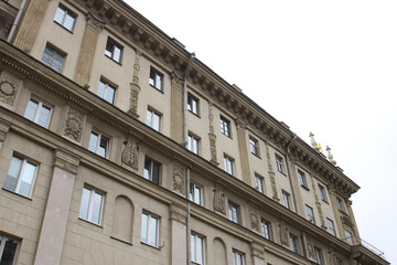 I gaze at a tall building adorned with balconies and windows