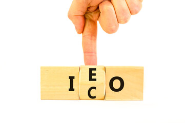 Initial coin or exchange offering symbol. Concept words abbreviation ICO or IEO on wooden block....