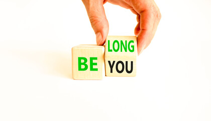 Belonging and belong symbol. Concept words Be you Belong on beautiful wooden block. Beautiful white background Businessman hand. Business motivational belonging and belong concept. Copy space.