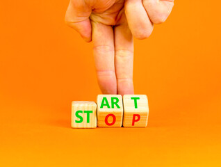 Start or stop symbol. Concept words Start or Stop on beautiful wooden block. Beautiful orange table...