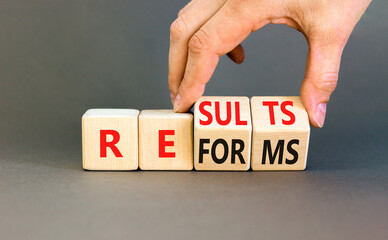 Reform and result symbol. Concept words Reforms Results on beautiful wooden block. Beautiful grey...