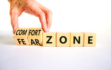 Comfort or fear zone symbol. Concept words Comfort zone Fear zone on wooden cubes. Beautiful white table white background. Psychologist hand. Business and comfort or fear zone concept. Copy space.