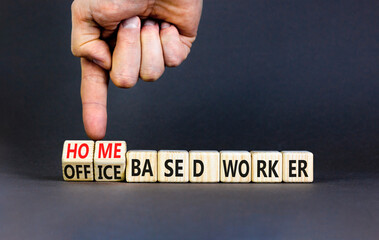 Home or office based worker symbol. Concept words Office based worker Home based worker on wooden cubes. Beautiful grey background. Business, home or office based worker concept. Copy space.