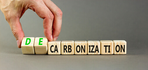 Decarbonization or carbonization symbol. Concept words Decarbonization or Carbonization on wooden blocks. Beautiful grey background. Business decarbonization or carbonization concept. Copy space.