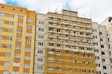 Thermal insulation works of the facade of a apartment building with mineral wool plates