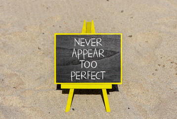 Never appear too perfect symbol. Concept words Never appear too perfect on beautiful black blackboard. Beautiful sand background. Business never appear too perfect concept. Copy space.