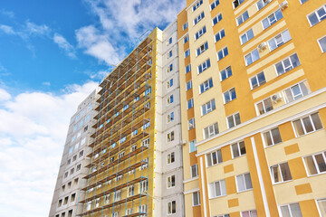 Fototapeta premium Thermal insulation works of the facade of a apartment building with mineral wool plates