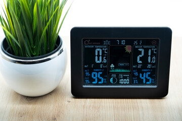 personal weather station device with weather conditions inside and outside. Home digital weather forecast concept with temperature (in celsius), humidity, pressure, moon phase,