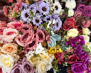 Beautiful rose flowers arrangement in many colors, from red, maroon, purple, pink, to blue color. Series of rose flower bouquet, with daisy flower and baby breath background.