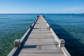 Fototapeta premium Morning view on crystal clear blue water of Plage du Debarquement white sandy beach near Cavalaire-sur-Mer and La Croix-Valmer, summer vacation on French Riviera, Var, France