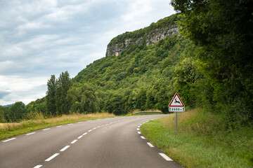 Driving car or camper on free road Route Napoleon in French Alps, touristic road in France