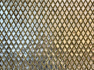 Silver diamond mosaic wall tiles with glossy reflective effects. Metallic shiny mosaic in silver color, in diamond shapes. beautiful reflection. Seamless texture.