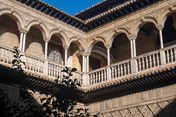 Fototapeta premium Walls of palace in historical Andalusian town Seville, Spain. View on houses, architectural details of buidings. Summer in Andalusia.