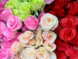 Beautiful rose flowers arrangement in various colors, from red, maroon, purple, pink color. Series of colorful rose flower bouquet seamless background texture.