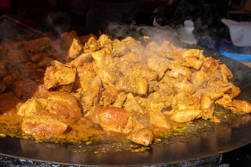 Street food, spicy pieces of meat from the grill for shawarma or kebab on weekly food market in...