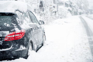 Parked car covered with snow  during snow storm