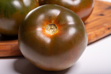 Fresh ripe sweet reddish brown and green kumato tomatoes close up