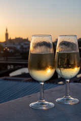 Drinking of cava or champagne sparkling wine on outdoor roof terrace with view on central part of...