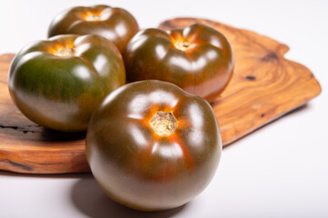 Fresh ripe sweet reddish brown and green kumato tomatoes close up
