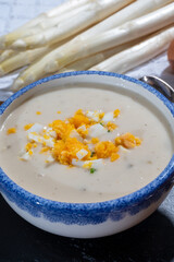 Spring season, homemade soup from raw white asparagus and cooked eggs, new harvest of Dutch, German white asparagus