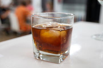Tasting Sherry sweat cream wine on ice rocks, jerez fortified wine made from palomino white grape...
